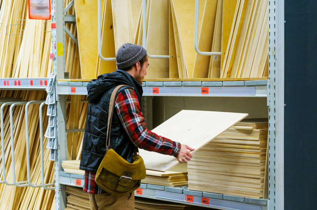 a person selecting plywood