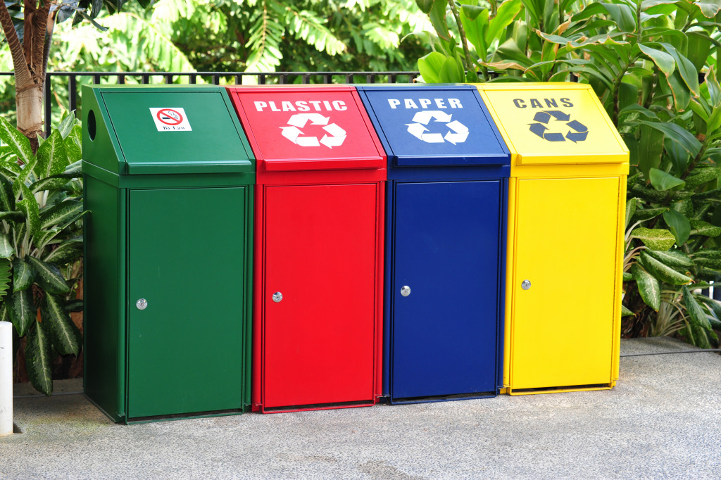 Recycling bins placed outside an office building.