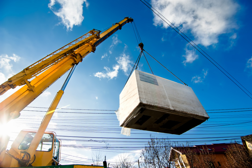 industrial crane lifting an electric generator